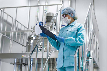 Photo of medical worker in full PPE holding a clipboard
